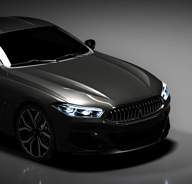 Vue de trois-quarts avant d'une voiture de sport gris foncé avec phares allumés à Poissy dans les Yvelines 78